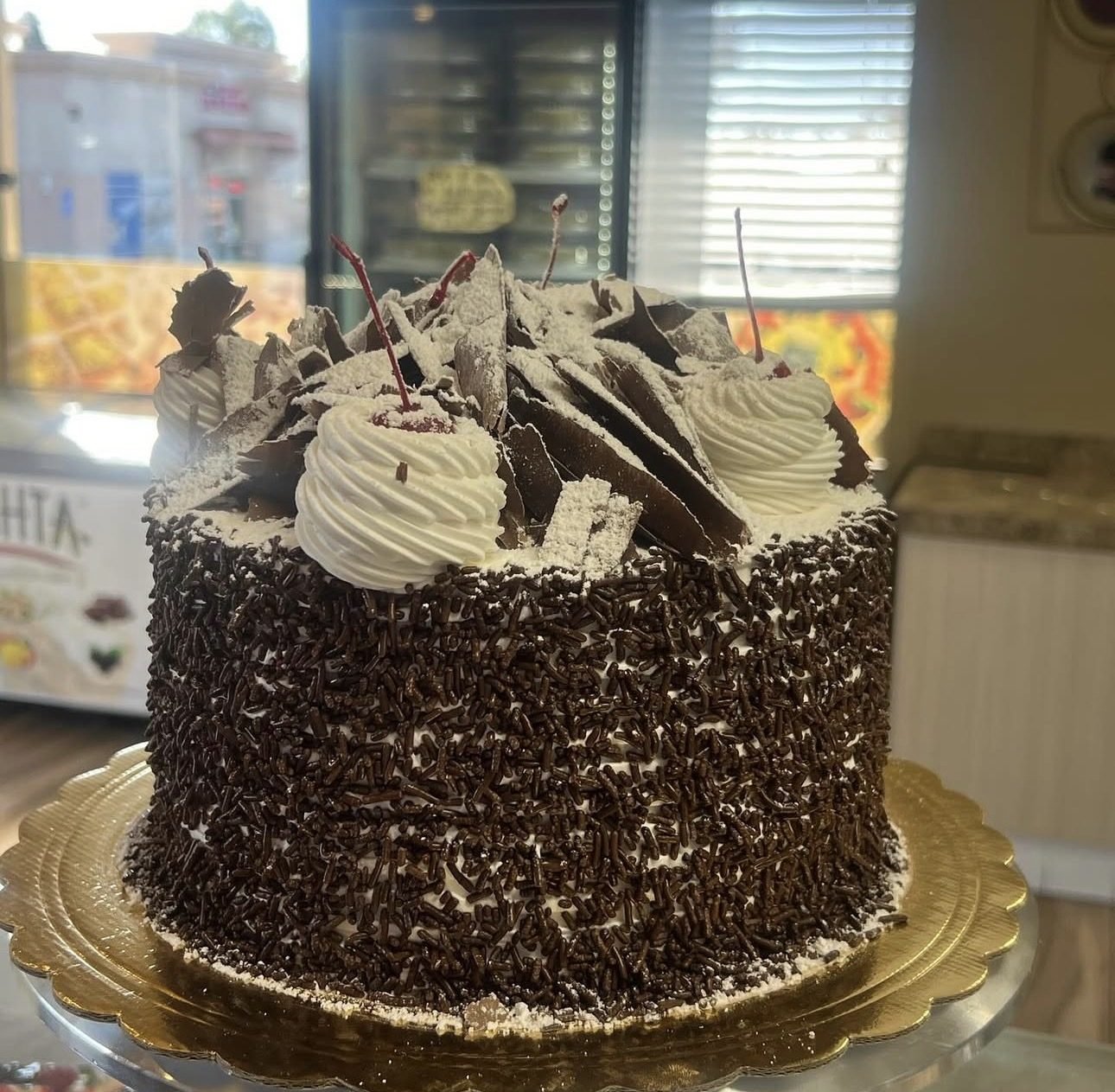Chocolate cake with whipped cream and chocolate shavings