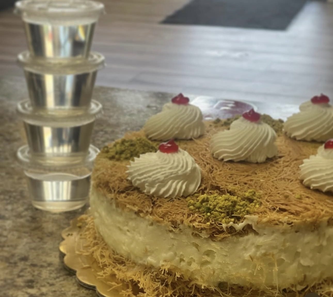 Golden pastry cake topped with cream rosettes and pistachio
