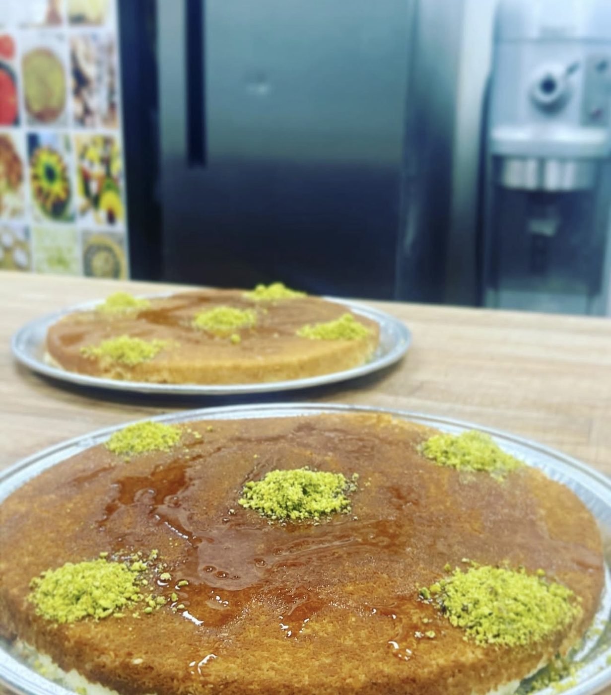Glazed pastry rounds topped with crushed pistachio